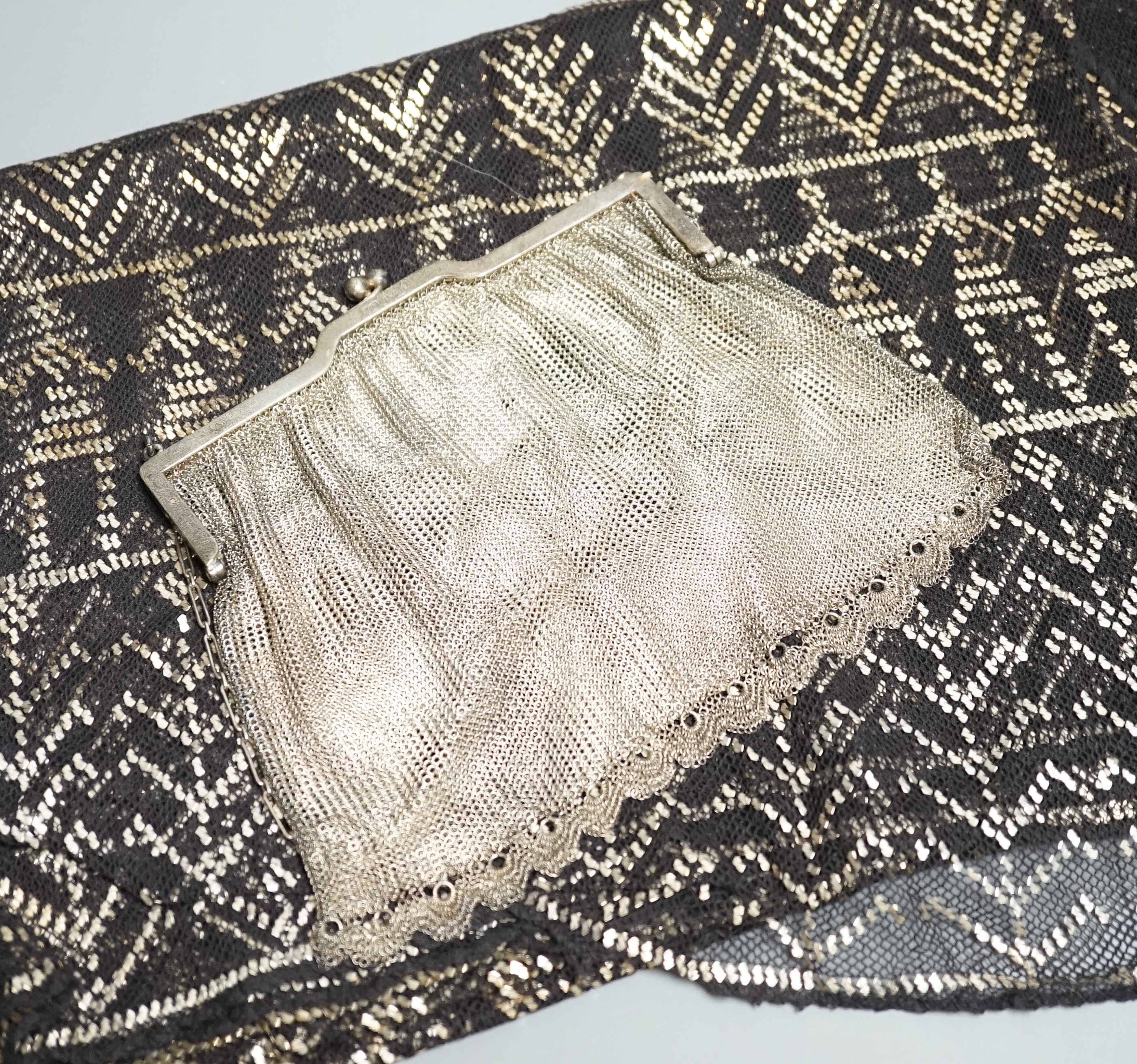 A vintage 1920's silver mesh evening bag, a black evening shawl woven with silver thread, length 240cm